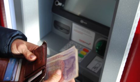 Person with Euros at ATM