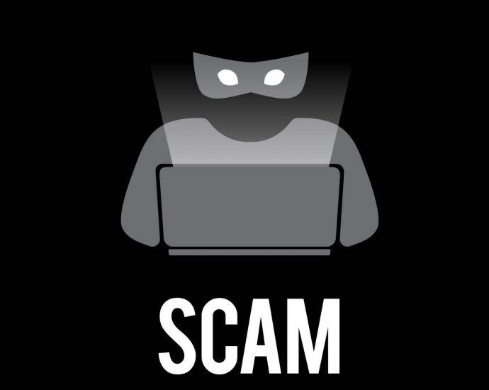 Graphic of criminal on computer with word SCAM