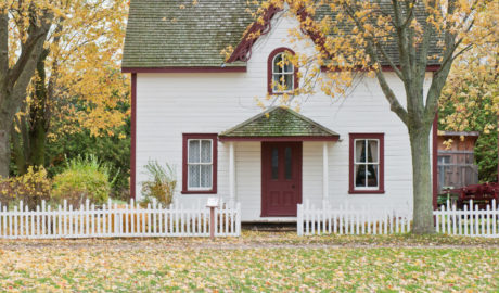 House in fall with leaves in front yard