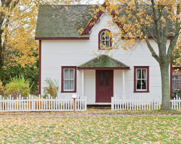 House in fall with leaves in front yard