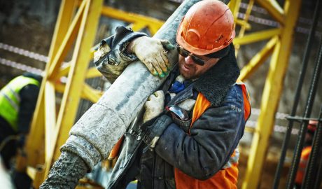 construction worker holding pipe