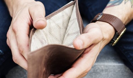 man holding open empty wallet