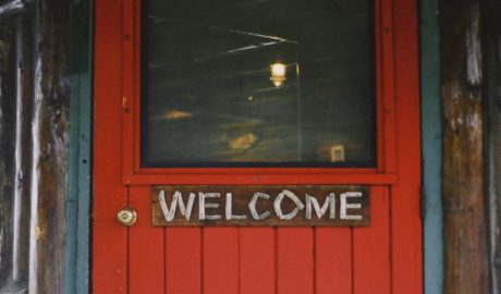 red door with welcome sign on it