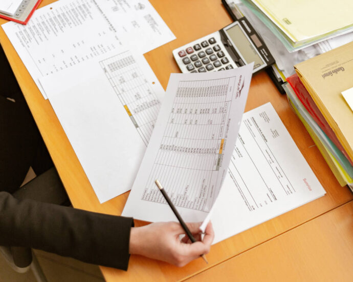 person working on spreadsheets at desk