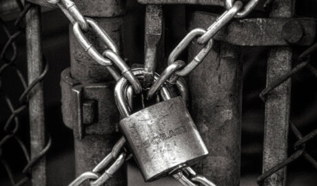 b/w closeup of chain locked to close gate