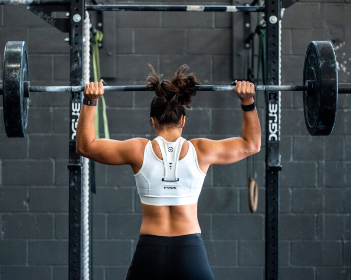 woman from back lifting weights