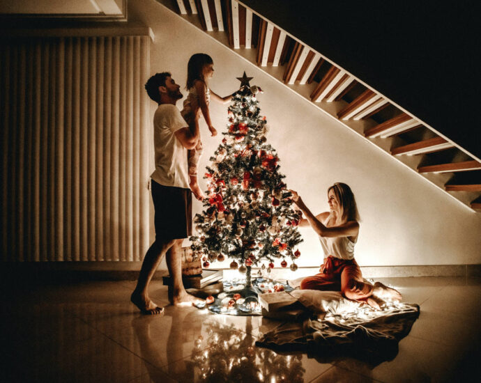 family decorating Christmas tree