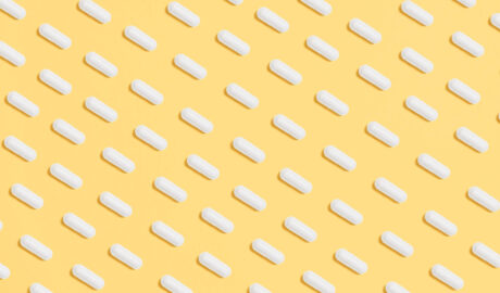 white pills on a yellow background