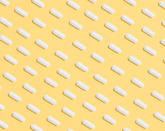 white pills on a yellow background