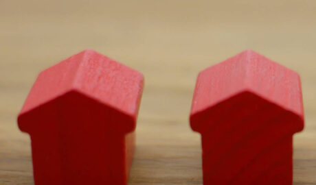 Two red Monopoly-type houses side by side