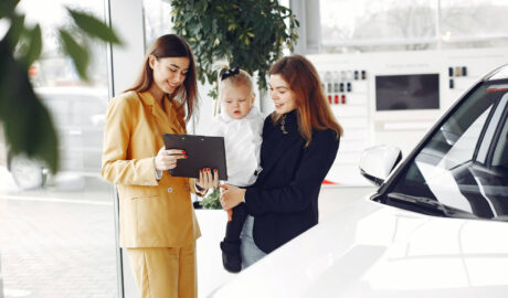 woman and baby at car dealership