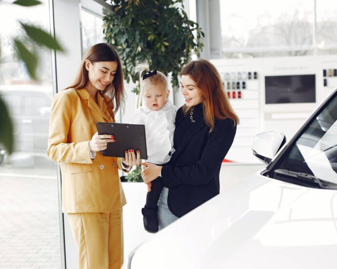 woman and baby at car dealership