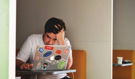 Man looking at computer with worried expression