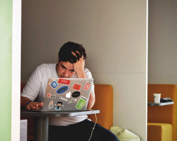 Man looking at computer with worried expression