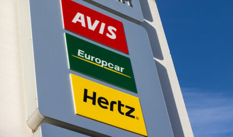 Rental car sign with Avis, Europcar and Hertz signage