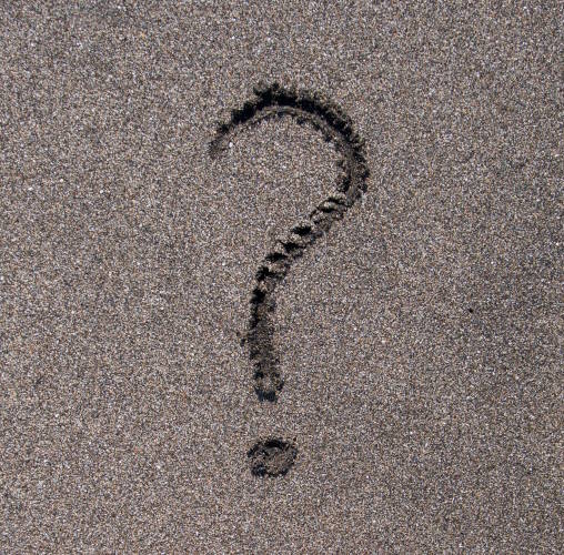 question mark drawn in the sand