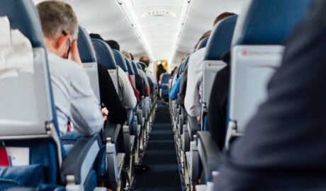 looking down row of an airplane with people in seats