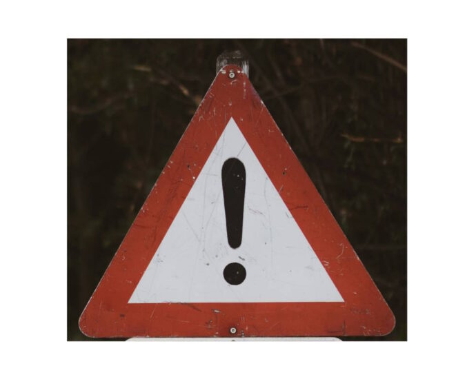 triangular warning sign with red outline and black ! in the middle