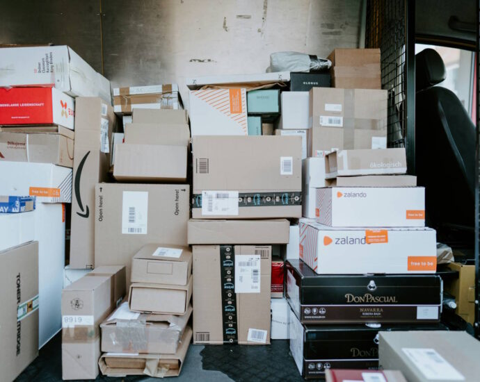 inside of delivery truck showing lots of stacked boxes