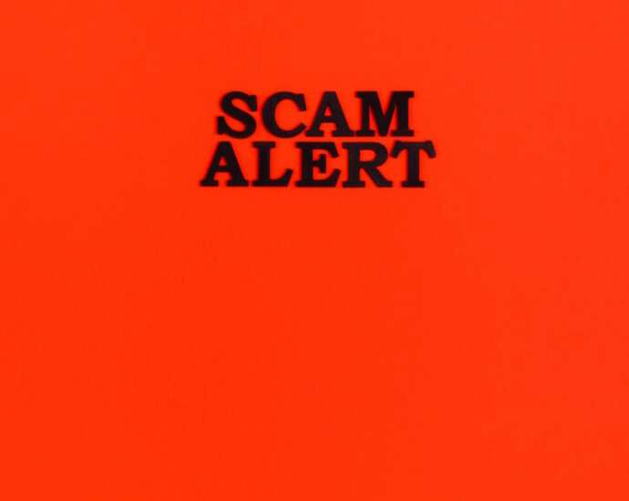 Red background with words "Scam Alert" in black