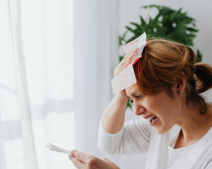 Frustrated woman paying bills