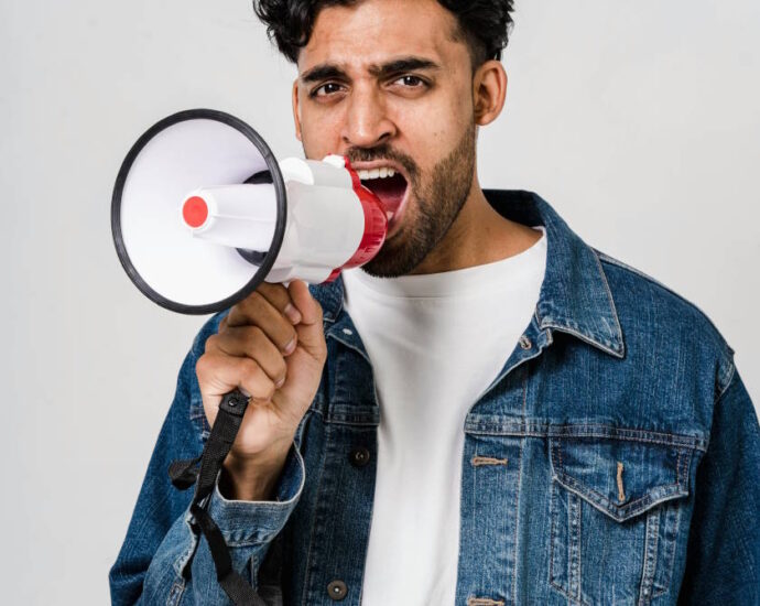 man yelling into bullhorn