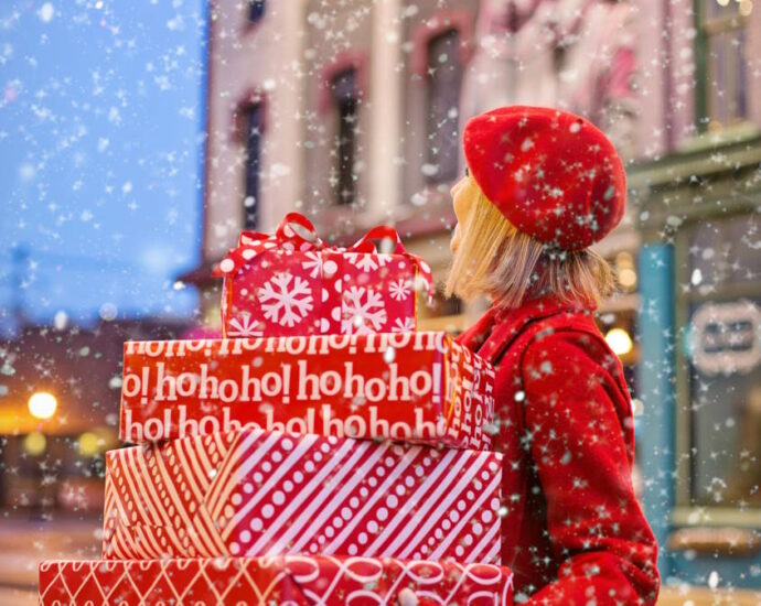 woman holding holiday presents in the snow