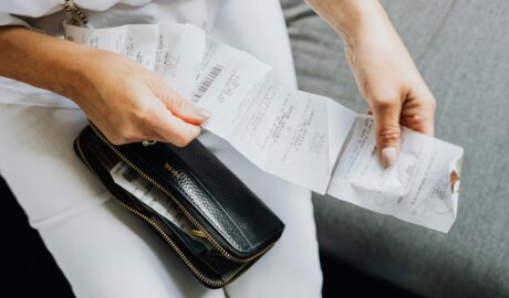 person looking over receipt